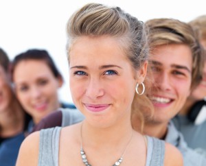 Closeup of young woman with people in background_small